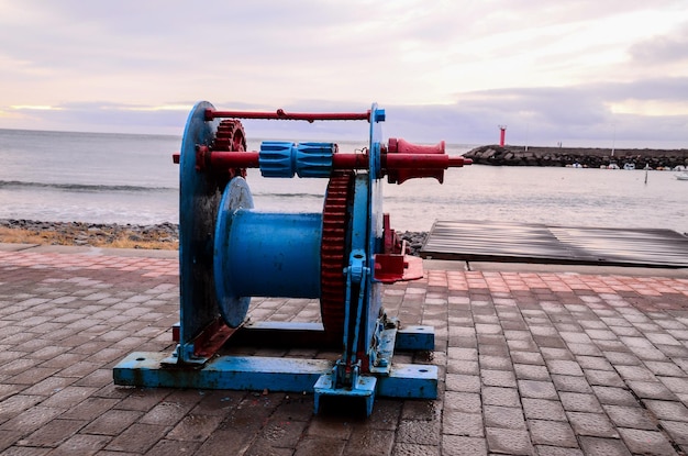 Old Vintage Metal Winch in a Port Harbor