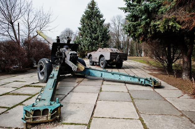 Old vintage military howitzer at city pedestal.