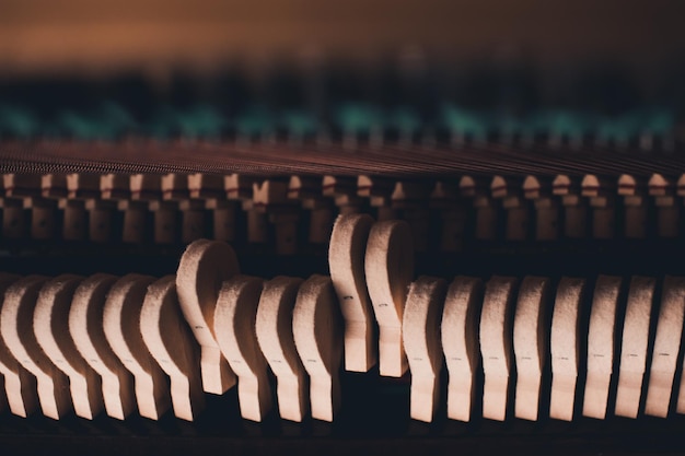 Old vintage piano hammers with strings close up Selective focus