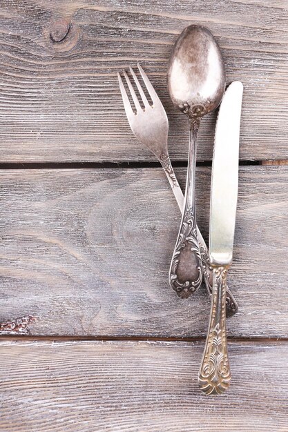 Old vintage silverware on wooden table