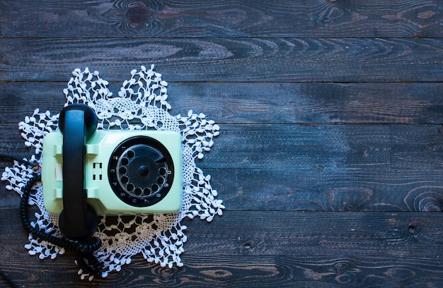 Old vintage telephone, on a wooden background