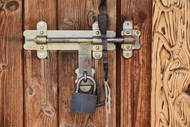 Old vintage wooden door with a padlock