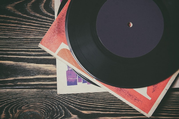 Old vinyl record on the wooden table