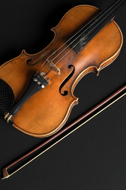 Old violin on a black background