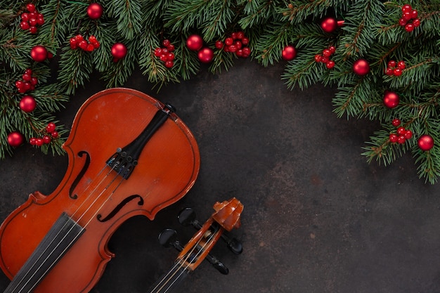 Old violin and fir-tree branches with Christmas decor.  Christmas and New Year's concept. 