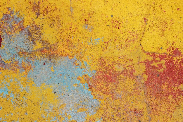 Old wall with peeling colored plaster, texture