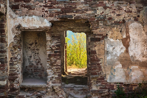 Old weathered ruined wall with breach from door, cracks and scratches, grunge background