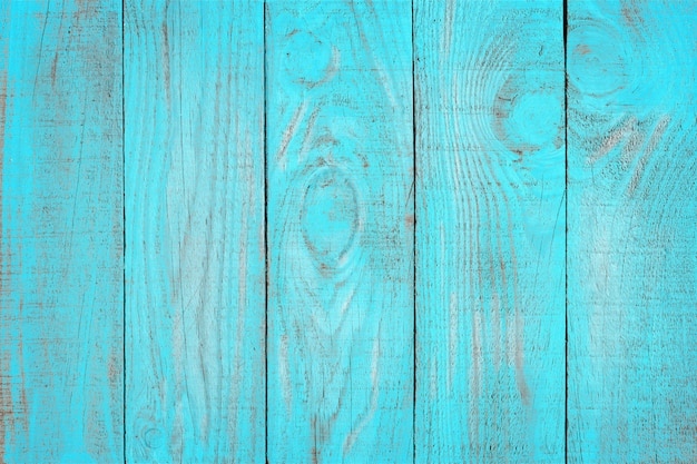 Old weathered wooden plank painted in turquoise blue color