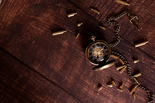 Old white alarm clock on a yellow background, flat lay. 