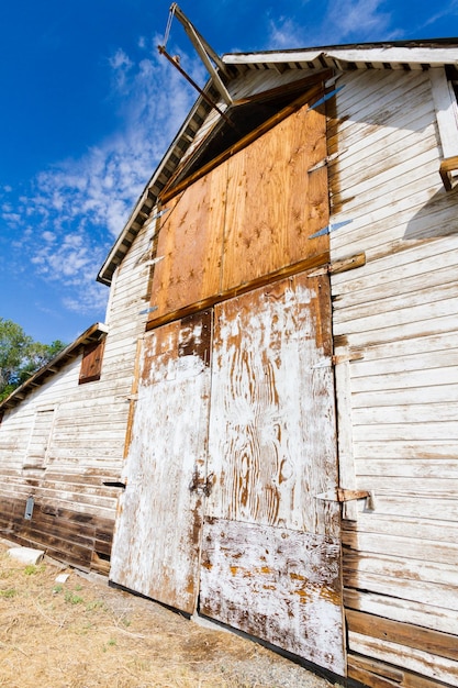 Old white barn with farm yard