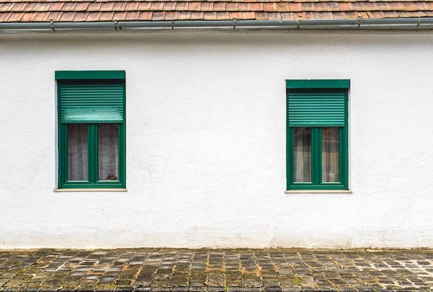 Old white house with green windows