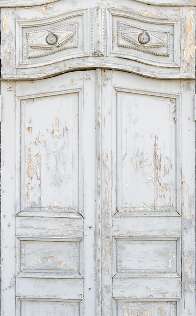 Old white vintage door with peeling paint