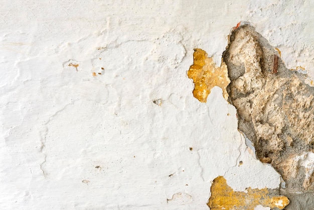 Old white wall with stones