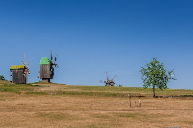 Old windmill on blue sky background