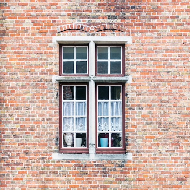 Photo old window on brick building wall