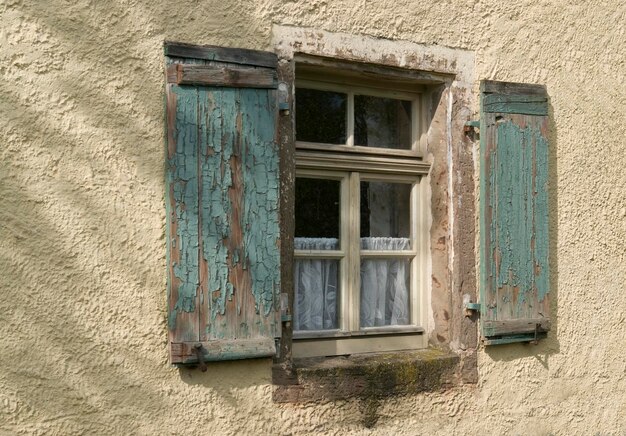 old window in plastered wall