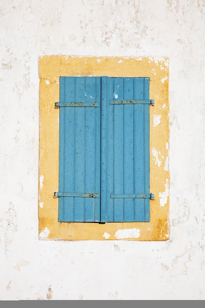 Old window with closed shutters