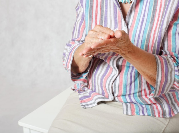 Old woman between 70 and 80 years old and a packet of wet wipes