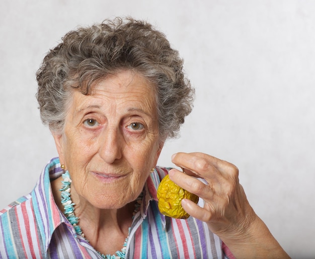 Old woman between 70 and 80 years old and shrivelled apple