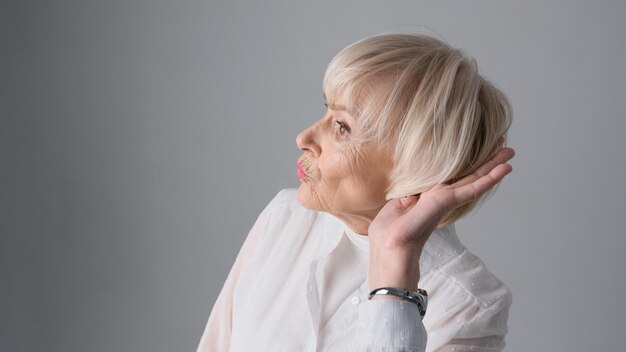 The old woman can hardly hear isolated on a white background