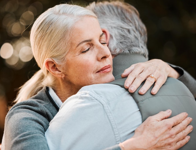 Old woman face and senior couple hug date and embrace with empathy care and elderly marriage trust love and support Park emotional connection and outdoor man retirement wife or people hugging