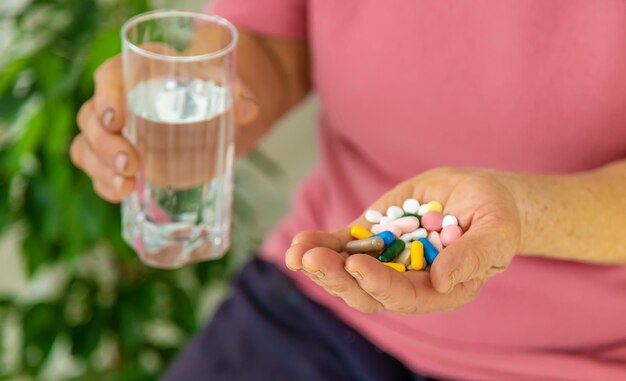 An old woman holds pills in her hands Selective focus Peopel