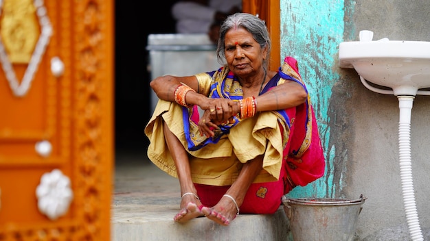 Old woman sitting on the stair