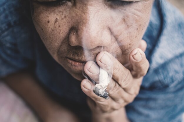 Old woman smoking cigarette