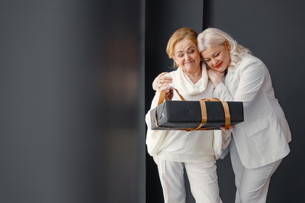 Old woman with her adult daughter celebrating Birthday