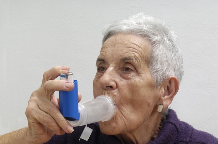 Old woman with an inhaler
