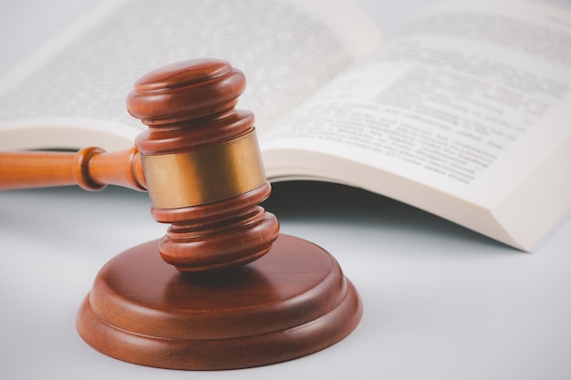 Old wood Judge hammer with law book on the table wood background, Used for adjudication and Justice.