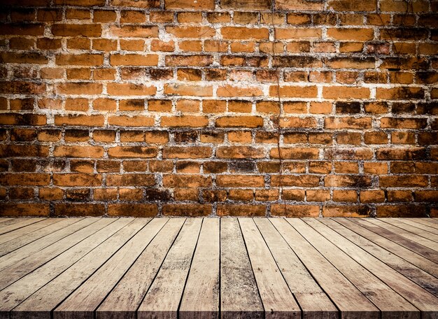 Photo old wood table or wood floor with old red brick wall perspective background for products display