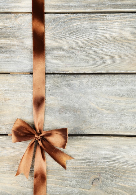 Old wooden background with beautiful bow