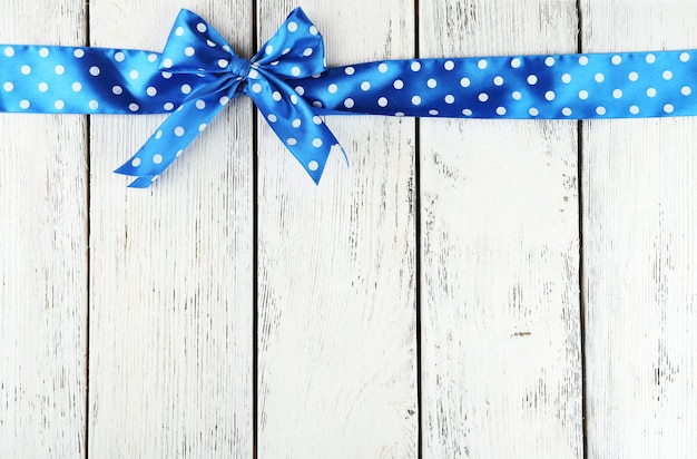 Old wooden background with beautiful bow