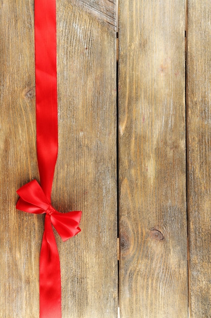 Old wooden background with beautiful bow