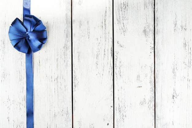 Old wooden background with beautiful bow