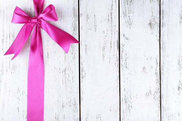 Old wooden background with beautiful bow