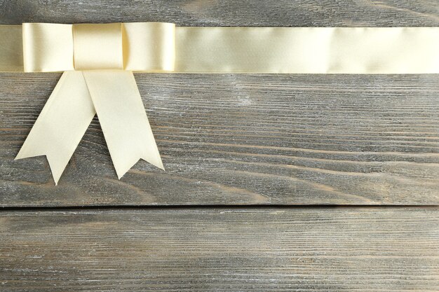 Old wooden background with beautiful bow