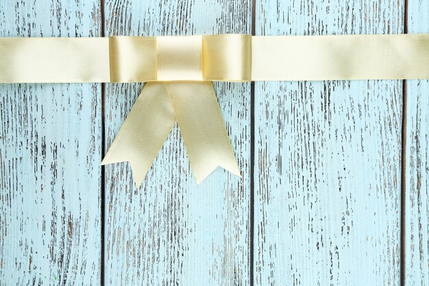 Old wooden background with beautiful bow