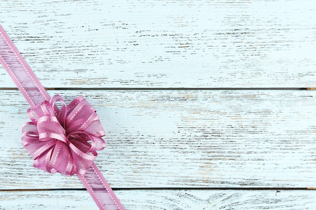 Old wooden background with beautiful bow