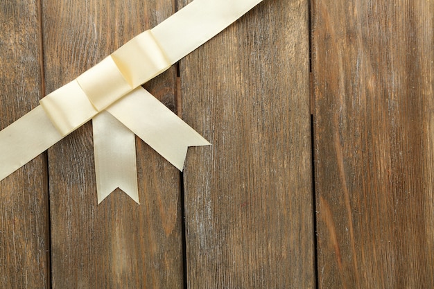 Old wooden background with beautiful bow