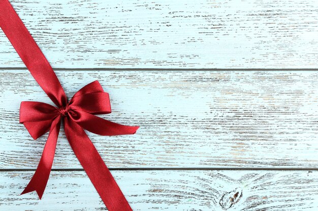 Old wooden background with beautiful bow