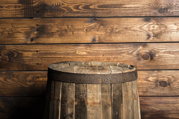 Photo old wooden barrel on a brown background