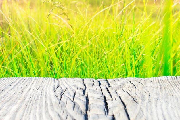 Old wooden board on a blurred yellowgreen background