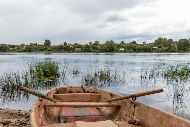 Old wooden boat on the river bank Rustic landscape