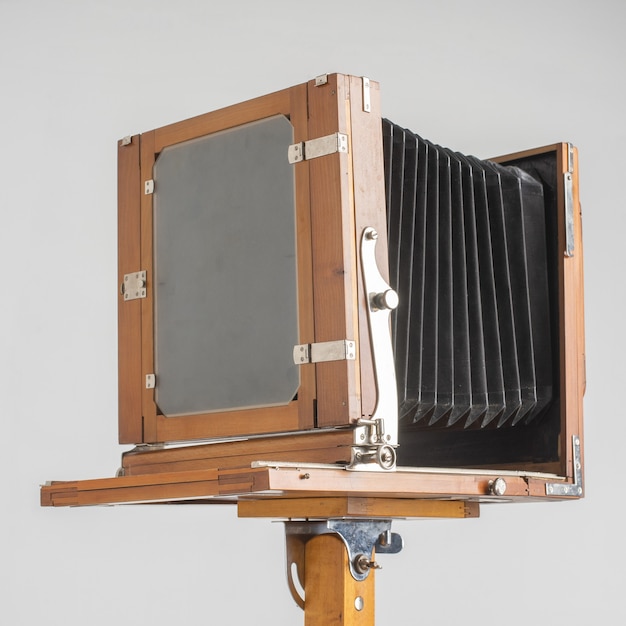 An old wooden camera of the last century with an accordion.