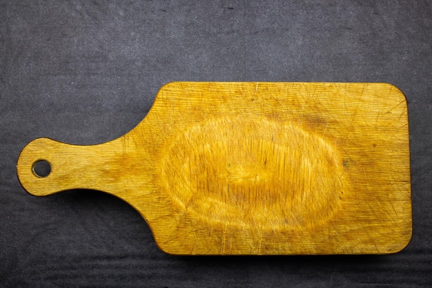 Old wooden cutting board Old scratched wooden board for the kitchen