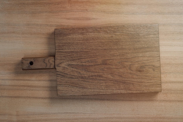 Old wooden cutting board on the table Flat lay top view with copy space