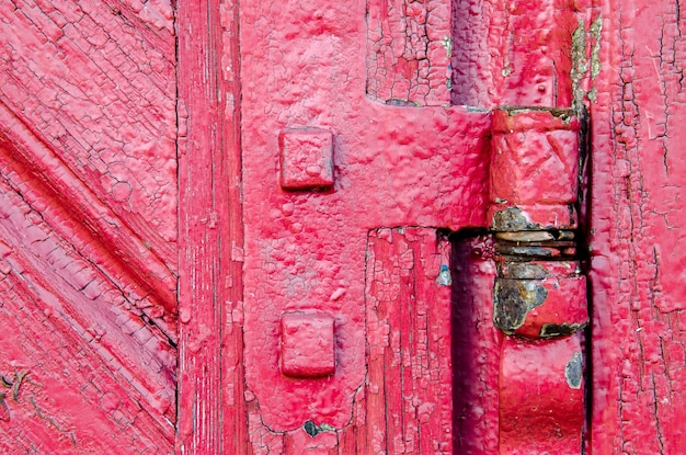 Old wooden door background red closeup