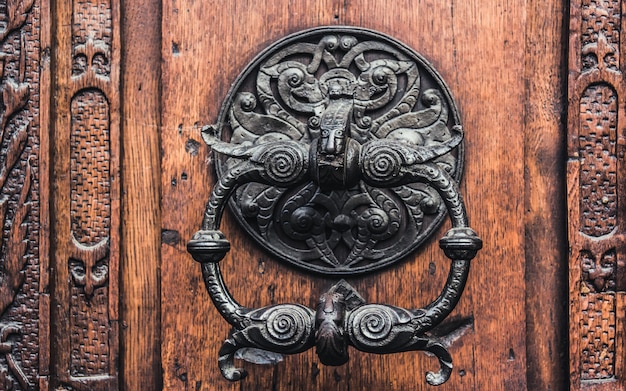 Old wooden door and iron door knocker.